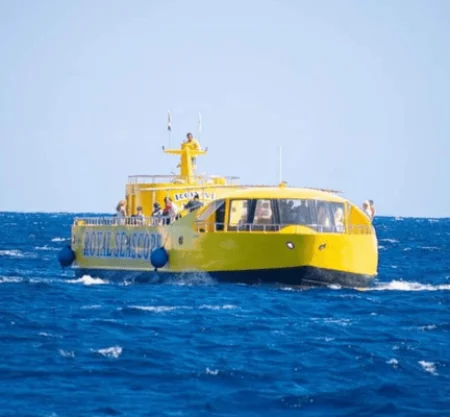 Yellow tourist submarine boat on blue ocean
