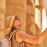 Visitor admiring ancient Egyptian columns.