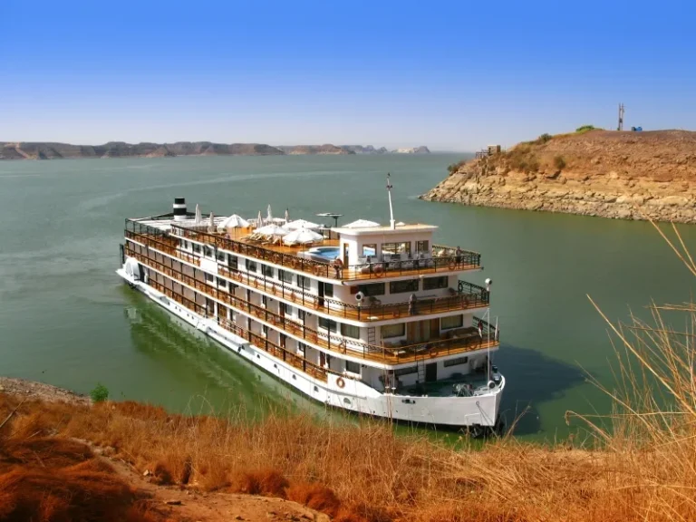 Luxury Lake Nasser river cruise ship on tranquil waters eploring Nubian landscapes, accompanied by Discovery Tours Egypt.