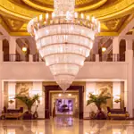 Opulent hotel lobby with grand chandelier.